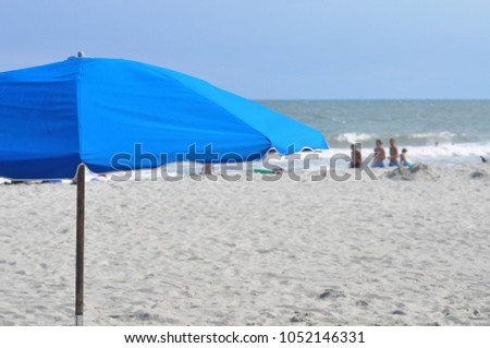Blue umbrella on the beach.
