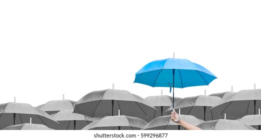Blue umbrella over dark umbrellas on white background. The difference to step up to leadership in business.hand of man holding a blue umbrella in raining. side view.