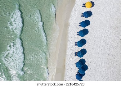 Blue Umbrellas On Beach Gulf Coast Panhandle Florida White Sandy Beach Clear Emerald Waters Fly Over With A Drone Aerial View Bright Sunny Day 