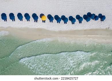 Blue Umbrellas On Beach Gulf Coast Panhandle Florida White Sandy Beach Clear Emerald Waters Fly Over With A Drone Aerial View Bright Sunny Day 