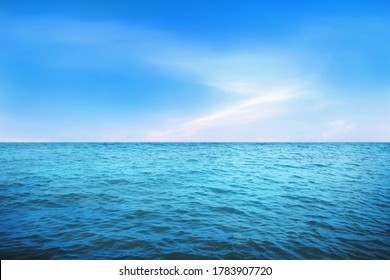 BLUE UNDER WATER waves and bubbles. Beautiful white clouds on blue sky over calm sea with sunlight reflection, Tranquil sea harmony of calm water surface. Sunny sky and calm blue ocean.