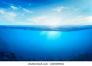 BLUE UNDER WATER waves and bubbles. Beautiful white clouds on blue sky over calm sea with sunlight reflection, Tranquil sea harmony of calm water surface. Sunny sky and calm blue ocean.
