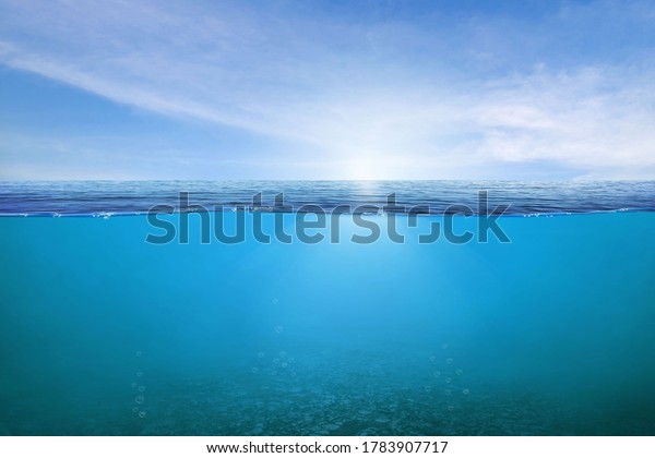 BLUE\
UNDER WATER waves and bubbles. Beautiful white clouds on blue sky\
over calm sea with sunlight reflection, Tranquil sea harmony of\
calm water surface. Sunny sky and calm blue ocean.\
