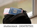 Blue United Arab Emirates passport with airline tickets on touristic backpack close up. Tourism and travel concept