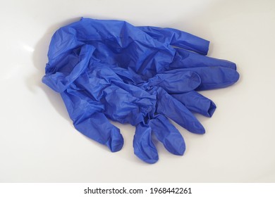 Blue Used Latex Gloves In White Sink.