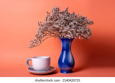 Blue Vase With Dried Flowers On An Orange Background. Minimalist Decor
