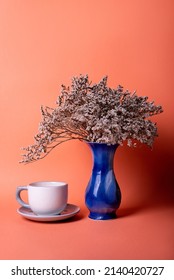 Blue Vase With Dried Flowers On An Orange Background. Minimalist Decor
