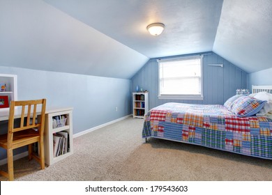 Blue vaulted ceiling room with carpet floor. Furnished with a white bed, bookshelf, desk
