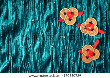 Blue velvet background with nine Chinese lucky coins