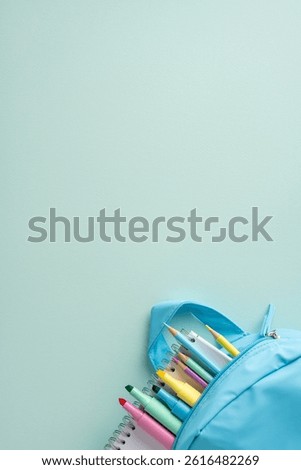 A blue vertical minimal backpack filled with various colorful stationery, including pens and notebooks, against a minimalistic pastel background
