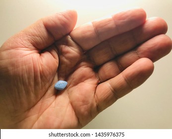 Blue Viagra Pill Stands On The Palm Health Pharmacy Drug Production Pill Viagra.