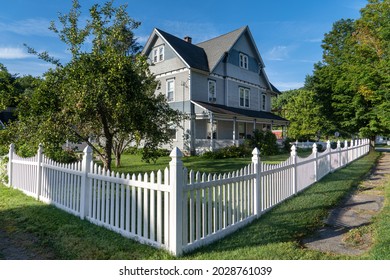 Blue Victorian mansion, inn in rural Pennsylvania, neatly restored with white picket fence blue sky - Shutterstock ID 2028761039