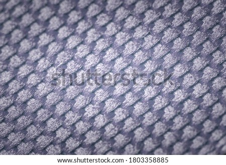 Blue vignetting dense fabric of synthetic braided threads as a background.