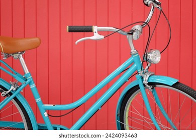 Blue vintage bicycle on red wooden wall background, close up of bicycle - Powered by Shutterstock