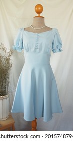Blue vintage party dress on a mannequin puff sleeve flare skirt Taylor made clothing neat stitching work online clothing store catalog seamstress fashion design works summer fashion blue sundress