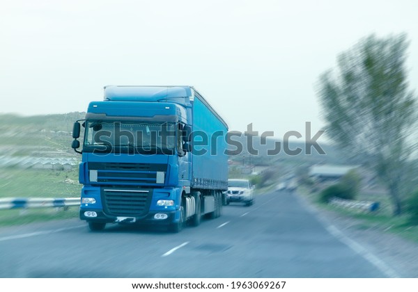 blue wagon on the\
highway in the evening