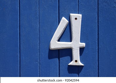 A Blue Wall With The Street Number Four On It