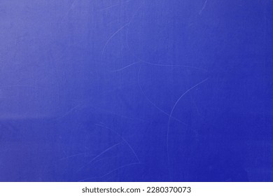 Blue wall, texture, background. The wooden wall, painted with enamel paint. Flat surface in bluish color. Smooth and glossy surface with a blue tint
