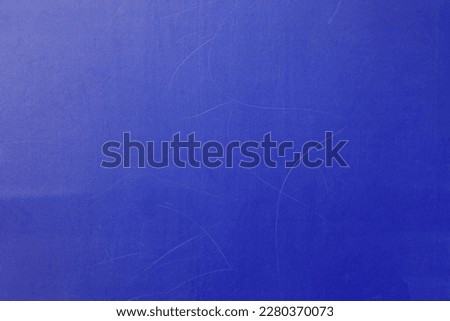 Blue wall, texture, background. The wooden wall, painted with enamel paint. Flat surface in bluish color. Smooth and glossy surface with a blue tint