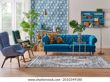 Blue wallpaper and sofa furniture style, decorative wooden palette bookshelf, gold lamp and middle table, vase of green plant, carpet and city view background.