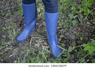 Blue water boots in field. - Powered by Shutterstock