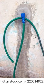 Blue Water Faucet With Green Water Hose