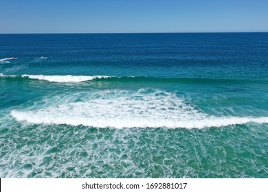 Blue water and green waves on a sunny day