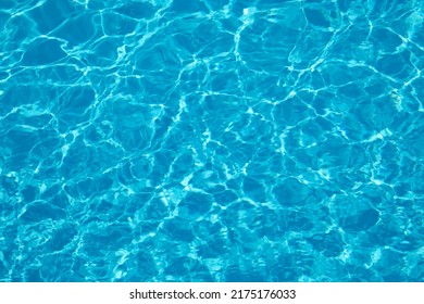 Blue water illuminated by the sun in the pool - Shutterstock ID 2175176033
