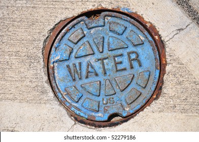 Blue water main cover on street