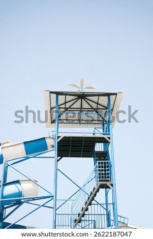 Blue Water Park Structure With Slide Under Clear Blue Sky