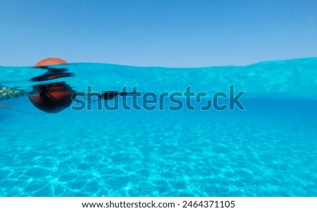 Blue water pool float Underwater split shot photos