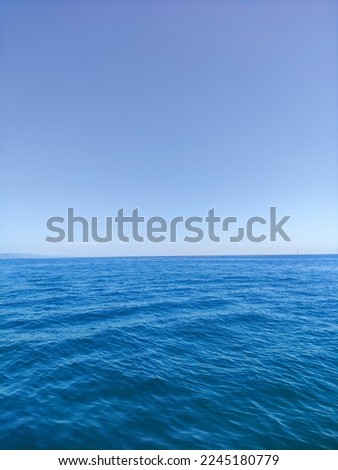 Similar – woman in red swimsuit walks by the sea. blurred