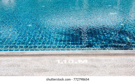 Blue Water In Swimming Pool With Edge