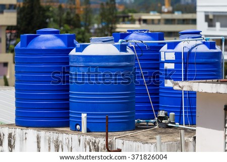 Blue water tanks of industrial building on roof top or deck in Phuket
