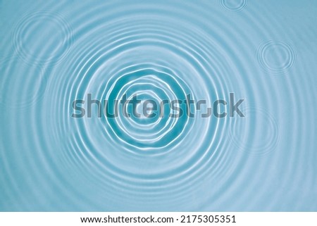 Blue water texture, surface with rings, ripples. Spa concept background