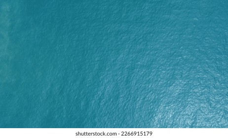 Blue water texture. Top view of the ocean surface with waves - Powered by Shutterstock