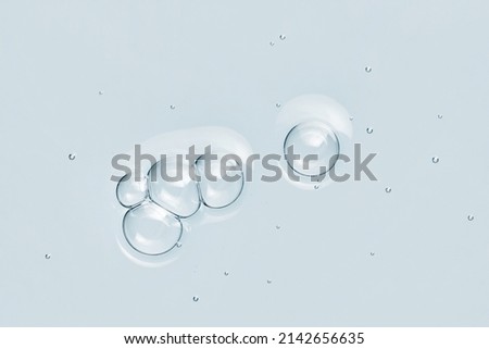 Blue water toner serum texture with bubbles. Skincare cosmetic liquid product closeup