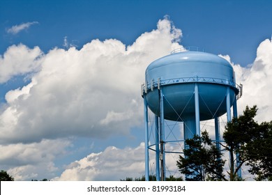 blue water tower under cloudy skies