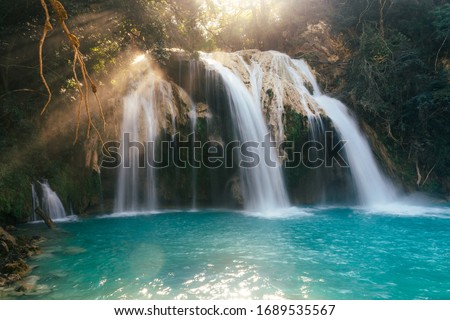 Blue waterfall in the mountains among the jungle in Mexico