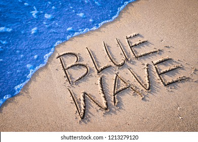 Blue Wave Political Message, A Prediction Of Democratic Turnout In American Elections, Handwritten In Smooth Sand On The Beach Shore