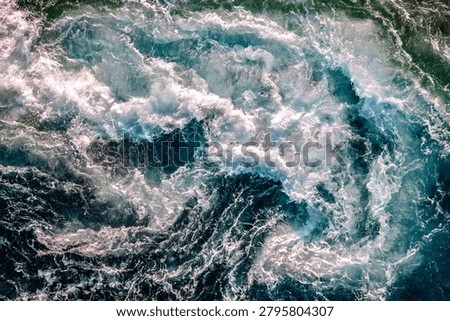 Blue waves abstract foam patterns of water of the river and the sea meet each other during high tide and low tide. Whirlpools of the maelstrom of Saltstraumen, Nordland , Norway.