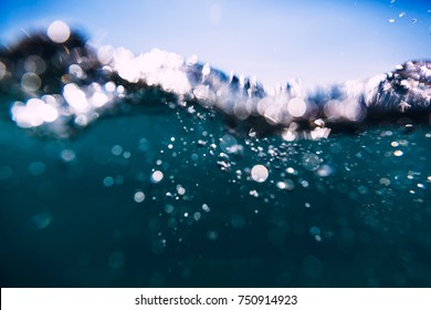 Blue Waves In Ocean. Water Texture And Bokeh.