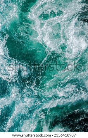 Blue waves of water of the river and the sea meet each other during high tide and low tide. Whirlpools of the maelstrom of Saltstraumen, Nordland , Norway.
