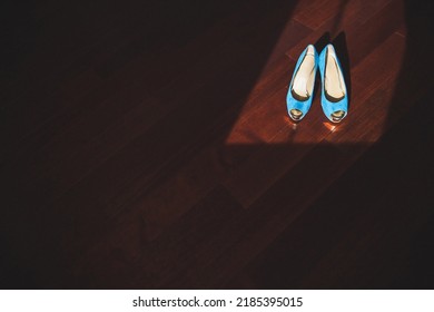 Blue Wedding Shoes Stand On A Wooden Floor.