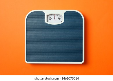 Blue weigh scales on orange background, top view - Shutterstock ID 1461075014