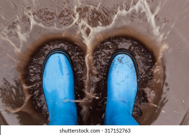  Blue Wellies Splashing In Mud Puddle.