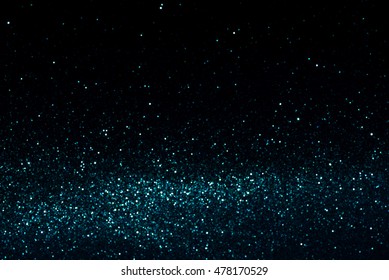 Blue And White Abstract Bokeh Lights. Defocused Background Aqua Blue Glitter Texture On A Black Background.