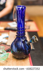 Blue, white, and black water pipe or bong on a table.