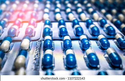 Blue And White Capsule Pills In Blister Pack. Pharmaceutical Industry. Antibiotics Drug Resistance. Antimicrobial Capsule Pills. Global Healthcare Concept. Pharmaceutical Manufacturing Production.