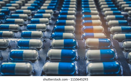 Blue And White Capsule Pills In Blister Pack. Pharmaceutical Industry. Antibiotics Drug Resistance. Antimicrobial Capsule Pills. Global Healthcare Concept. Pharmaceutical Manufacturing Production.